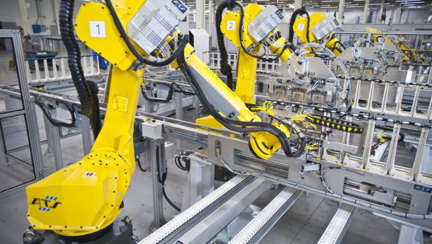 ABB robots feeding IV bags onto conveyor,