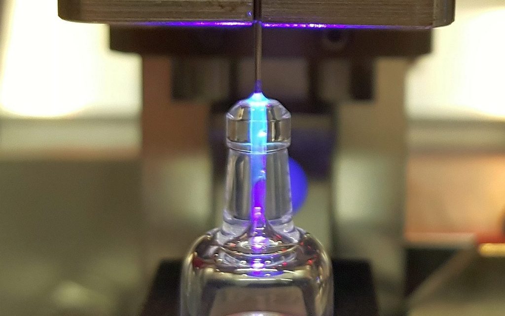 Close-up view of cannula in glass hub of needle and undergoing curing