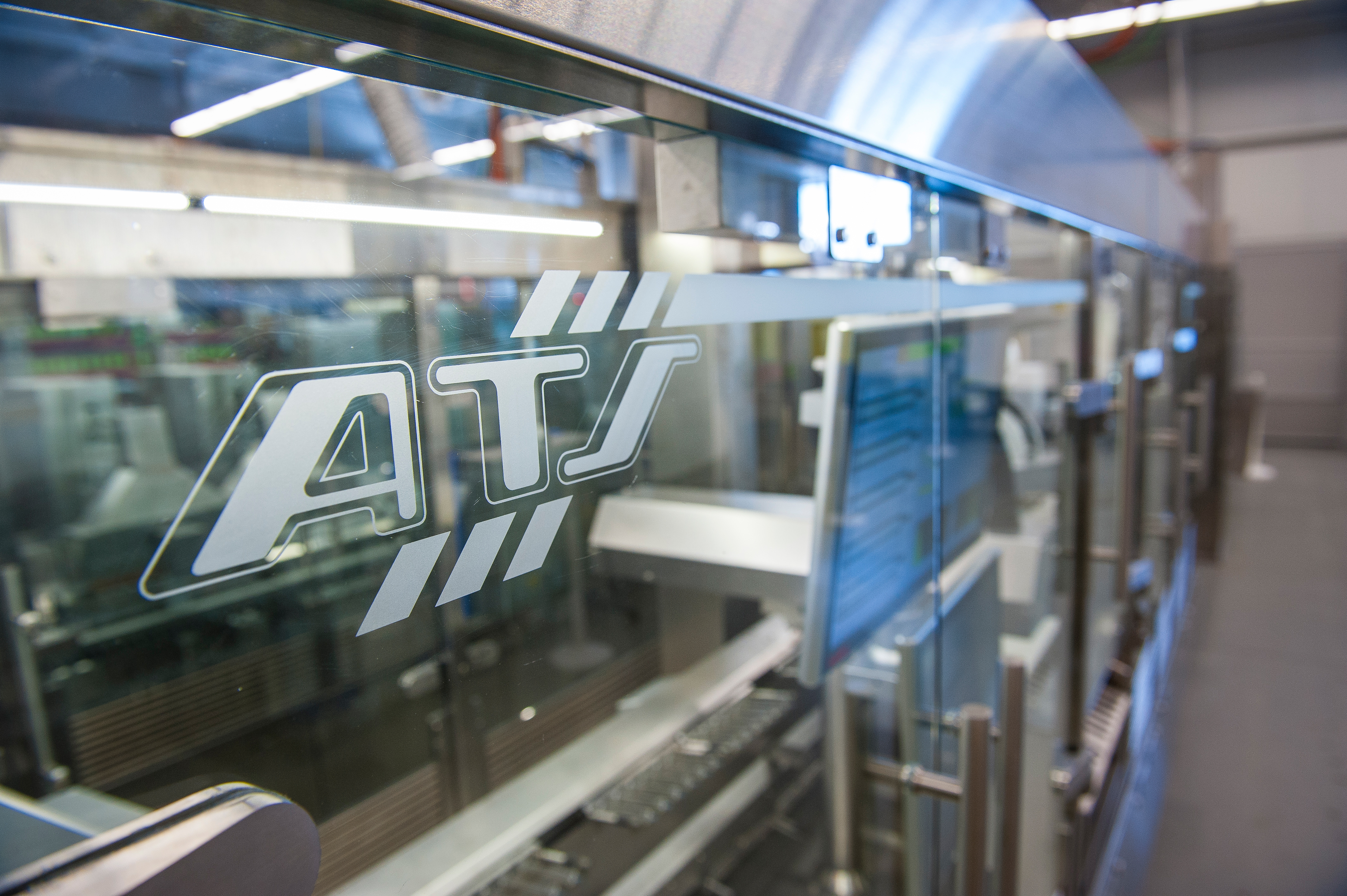 ATS logo on clear guard door for machine